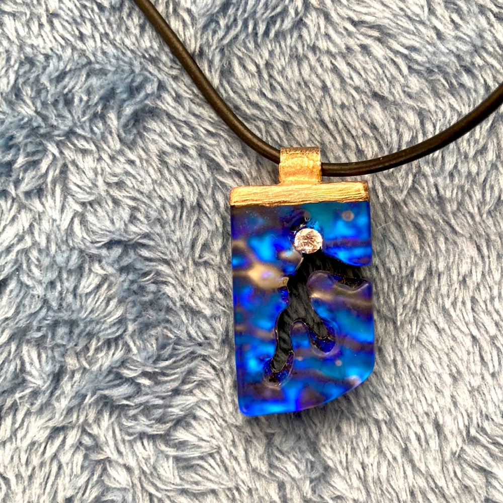 NWOT -contemporary iridescent resin one-of-a-kind pendant with black cord.
